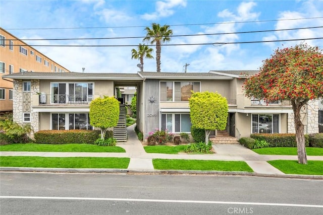 2049 E 3rd St Unit 3, Long Beach, CA 90814 - view of property featuring stairway, a front yard, and stone siding