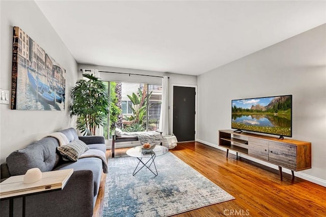 living room featuring baseboards and wood finished floors