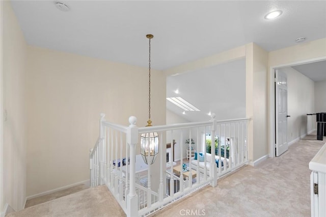 corridor with carpet, recessed lighting, baseboards, an upstairs landing, and vaulted ceiling