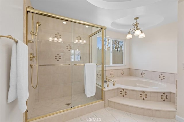 bathroom featuring tile patterned floors, a shower stall, a garden tub, and a chandelier