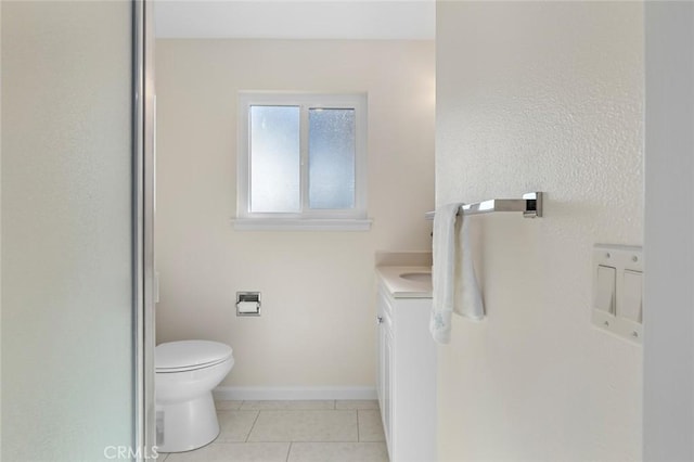 bathroom with tile patterned floors, baseboards, vanity, and toilet