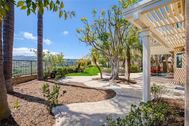 view of yard with a fenced backyard, a pergola, and a patio