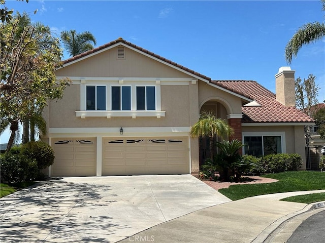 view of front of property with an attached garage, a tile roof, stucco siding, a chimney, and concrete driveway