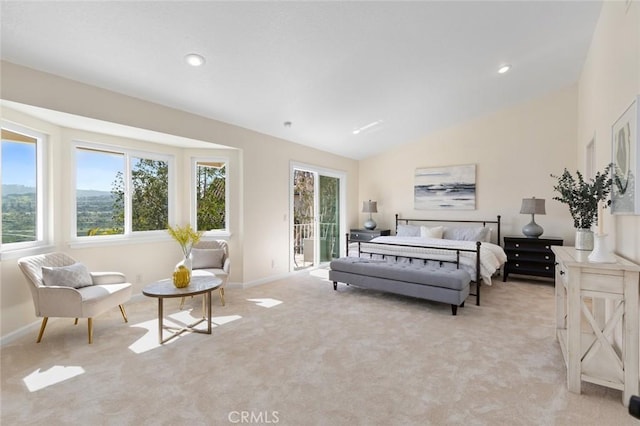 bedroom with light colored carpet, lofted ceiling, and access to exterior