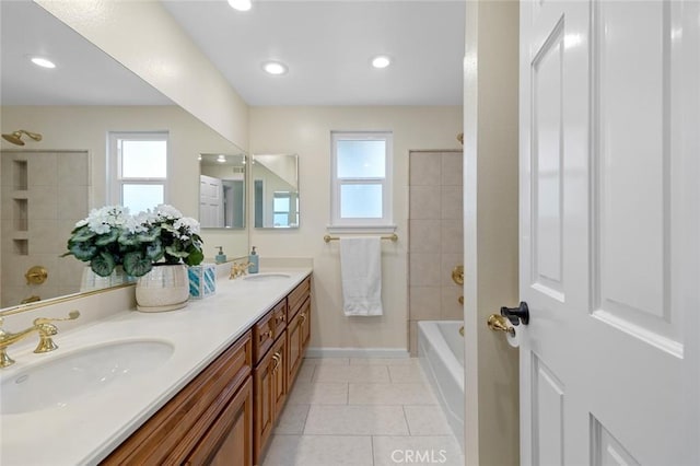 bathroom with a sink, tile patterned flooring, bathtub / shower combination, double vanity, and baseboards