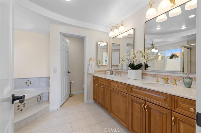 full bathroom with double vanity, a sink, tile patterned floors, and toilet