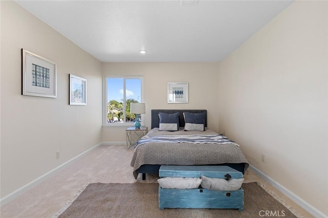 bedroom with carpet floors and baseboards