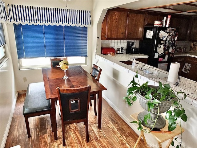 3915 Valencia Ave, San Bernardino, CA 92404 - dining area featuring baseboards and wood finished floors