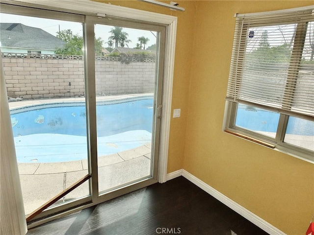 3915 Valencia Ave, San Bernardino, CA 92404 - doorway to outside with baseboards, dark wood finished floors, and a wealth of natural light
