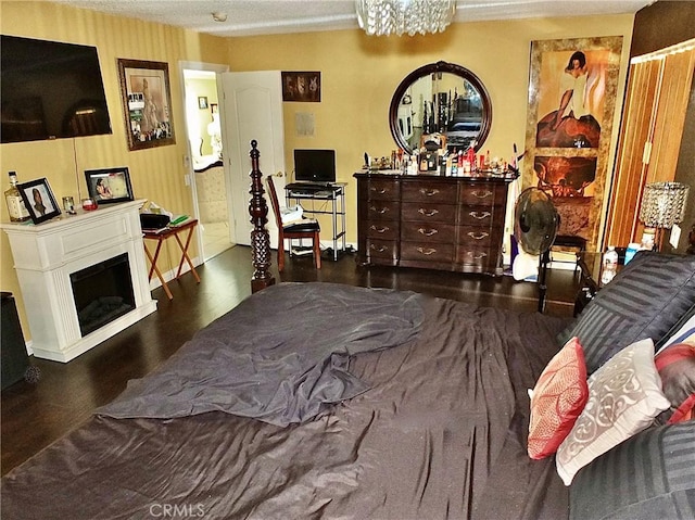 3915 Valencia Ave, San Bernardino, CA 92404 - bedroom with baseboards, a glass covered fireplace, and wood finished floors