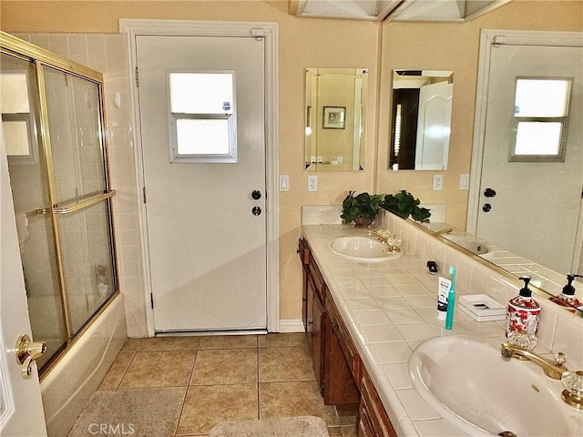 3915 Valencia Ave, San Bernardino, CA 92404 - bathroom with double vanity, enclosed tub / shower combo, a sink, and tile patterned flooring