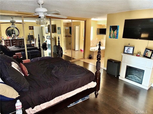 3915 Valencia Ave, San Bernardino, CA 92404 - bedroom featuring a textured ceiling, a glass covered fireplace, and wood finished floors