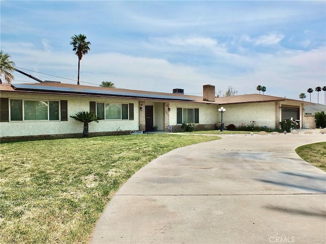 3915 Valencia Ave, San Bernardino, CA 92404 - single story home with a garage, driveway, a front yard, and solar panels