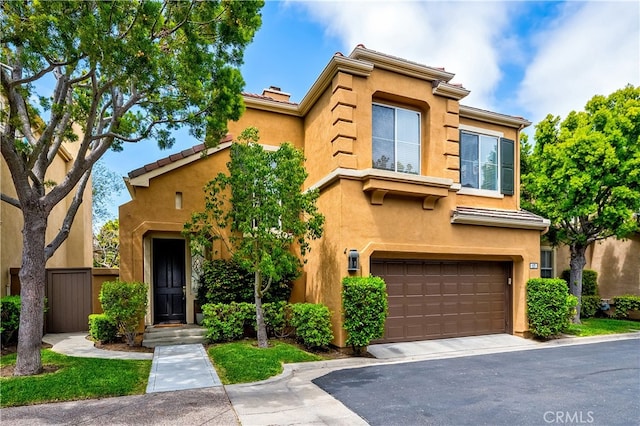 17 Calvados, Newport Coast, CA 92657 - mediterranean / spanish-style house featuring an attached garage, stucco siding, a tile roof, and fence