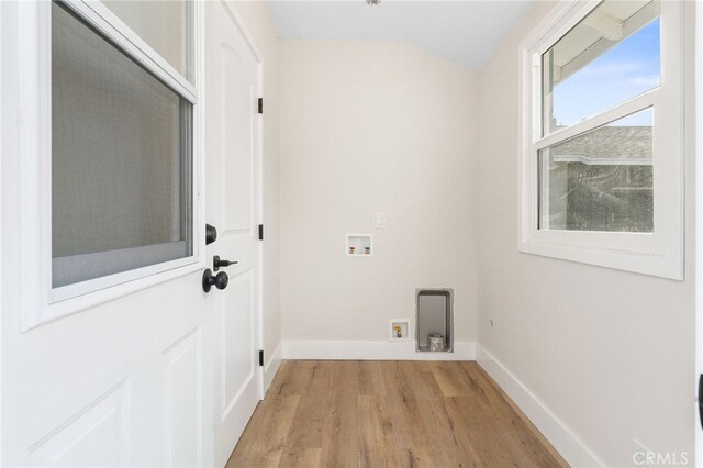 laundry area featuring baseboards, laundry area, light wood-type flooring, and hookup for a washing machine