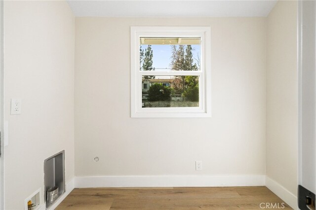empty room featuring baseboards and wood finished floors