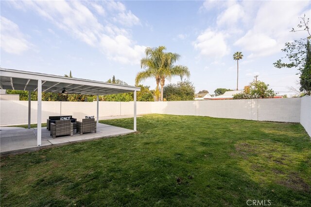 view of yard featuring a fenced backyard, an outdoor living space, and a patio area