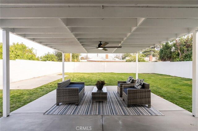 view of patio featuring a fenced backyard, a ceiling fan, and an outdoor hangout area