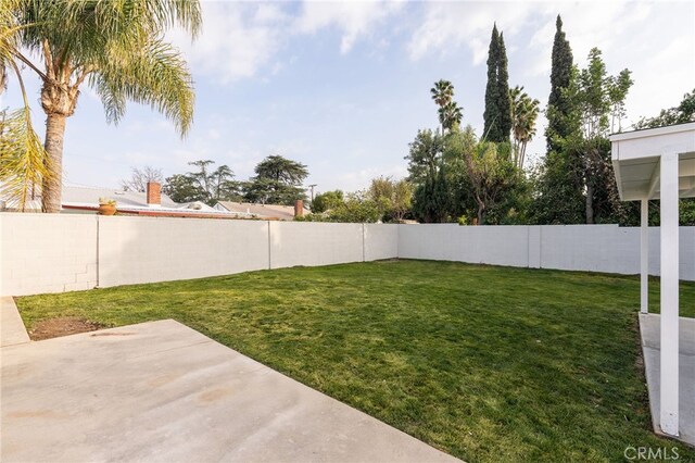 view of yard featuring a patio and a fenced backyard