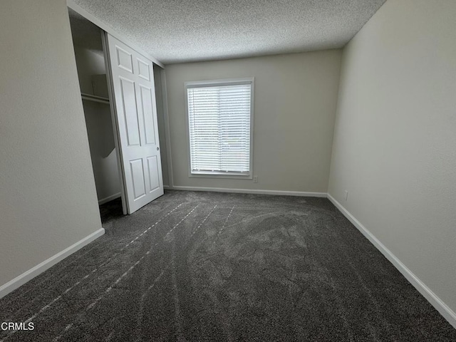 1300 Saratoga Ave Unit 2204, Ventura, CA 93003 - unfurnished bedroom featuring carpet floors, baseboards, and a textured ceiling