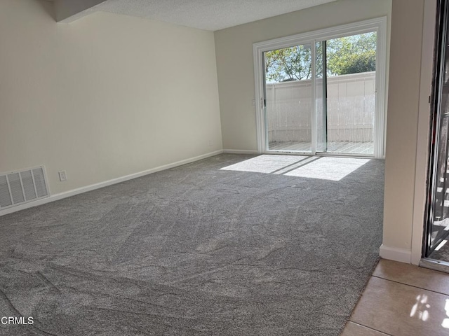1300 Saratoga Ave Unit 2204, Ventura, CA 93003 - tiled spare room featuring carpet floors, a textured ceiling, baseboards, and visible vents