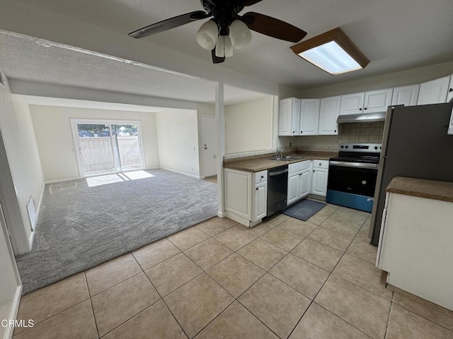1300 Saratoga Ave Unit 2204, Ventura, CA 93003 - kitchen with dark countertops, light carpet, stainless steel appliances, open floor plan, and light tile patterned floors