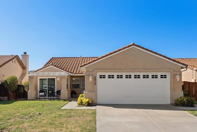 single story home with an attached garage, stucco siding, a front yard, and concrete driveway
