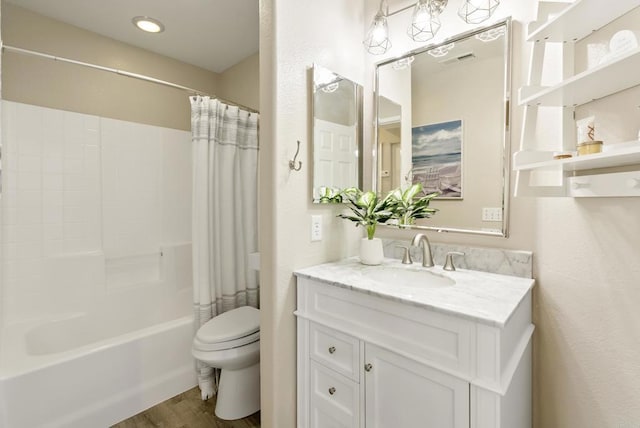 bathroom with visible vents, wood finished floors, shower / tub combo, vanity, and toilet