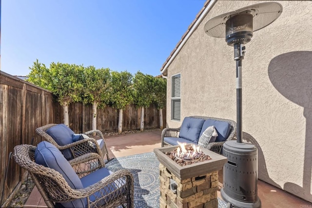 view of patio / terrace with a fenced backyard and an outdoor fire pit