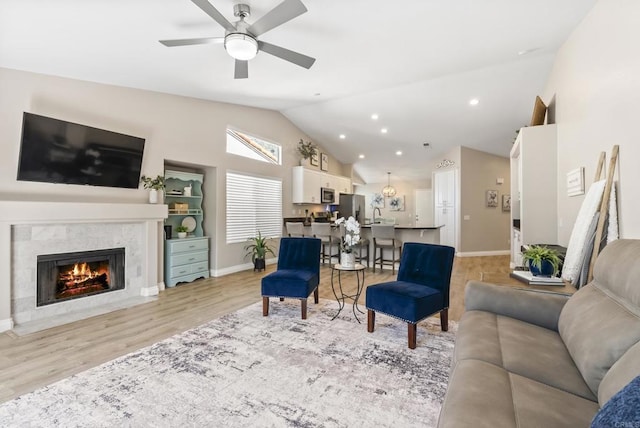 4972 Lake Shore Ct, Fallbrook, CA 92028 - living area with ceiling fan, light wood-style floors, a fireplace with flush hearth, baseboards, and high vaulted ceiling