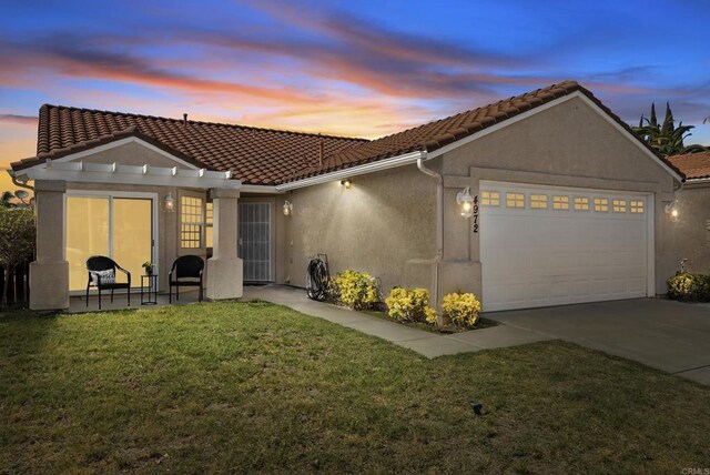 4972 Lake Shore Ct, Fallbrook, CA 92028 - back of house featuring a garage, a tile roof, a yard, and stucco siding