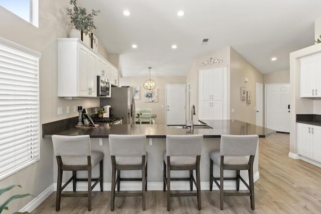4972 Lake Shore Ct, Fallbrook, CA 92028 - kitchen featuring stainless steel appliances, a sink, dark countertops, white cabinets, and recessed lighting