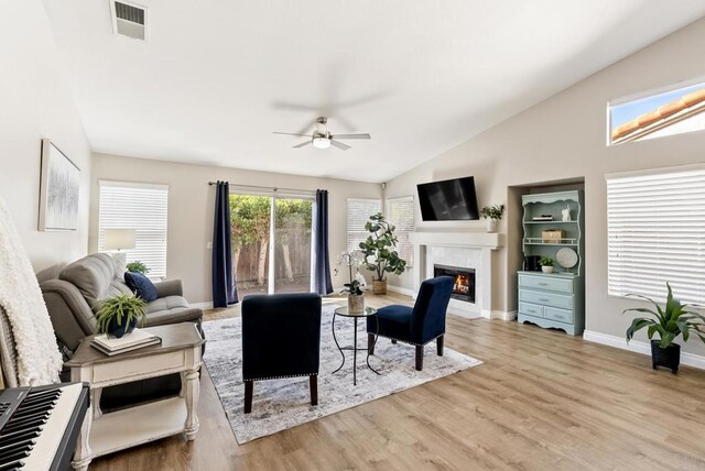 4972 Lake Shore Ct, Fallbrook, CA 92028 - living room with a glass covered fireplace, lofted ceiling, ceiling fan, wood finished floors, and baseboards