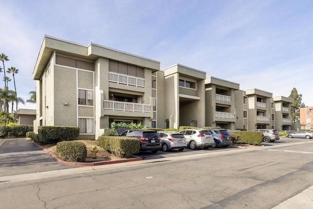 view of property featuring uncovered parking