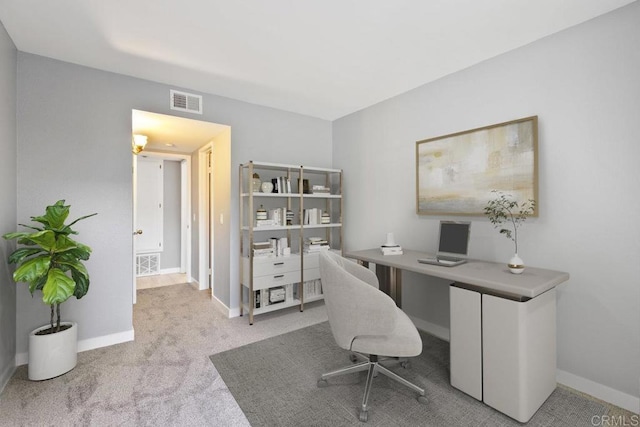 office space with carpet floors, baseboards, and visible vents