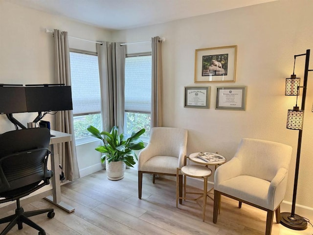 office with baseboards and light wood-style flooring