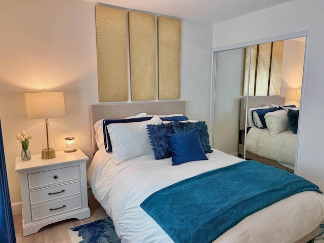 bedroom featuring a closet and wood finished floors