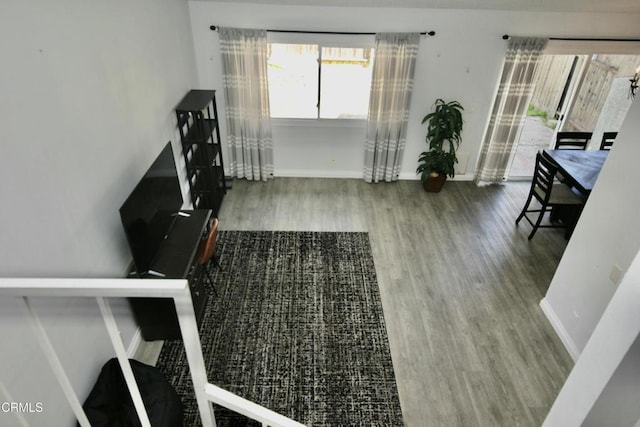 living area featuring baseboards and wood finished floors