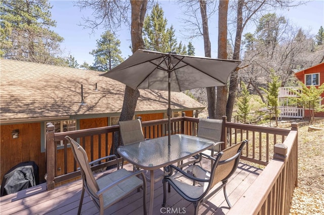 wooden deck featuring outdoor dining area