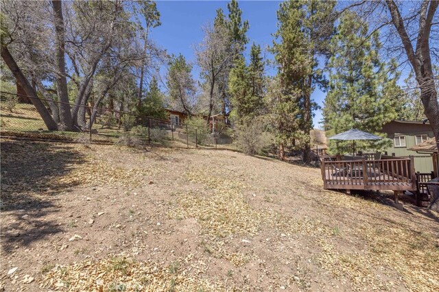 view of yard with fence and a wooden deck