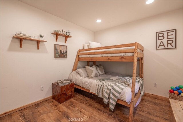 bedroom with recessed lighting, baseboards, and wood finished floors
