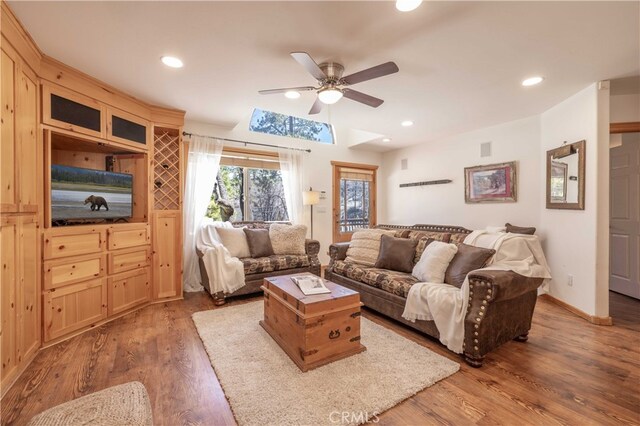 living room featuring a ceiling fan, recessed lighting, wood finished floors, and visible vents