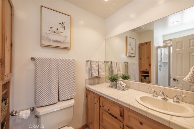full bath with toilet, a shower stall, and vanity