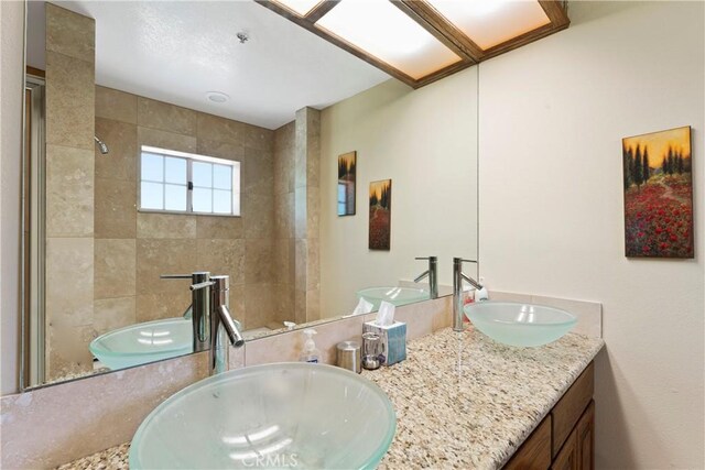 1031 Black Oaks Dr, Lake Arrowhead, CA 92352 - bathroom featuring a tile shower and double vanity