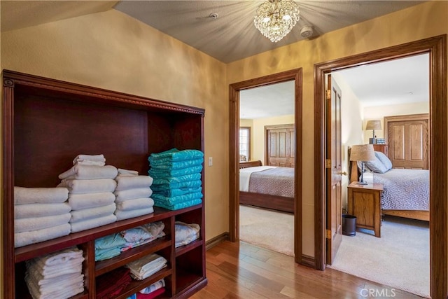 1031 Black Oaks Dr, Lake Arrowhead, CA 92352 - bedroom with wood finished floors and a chandelier