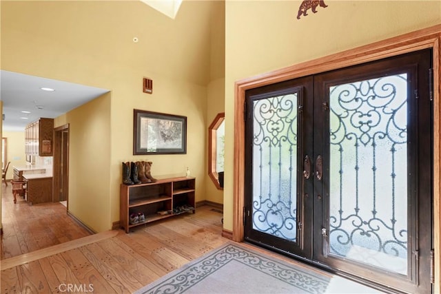 1031 Black Oaks Dr, Lake Arrowhead, CA 92352 - foyer featuring french doors, light wood-type flooring, and a towering ceiling