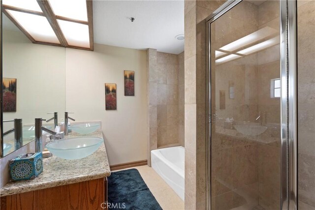 1031 Black Oaks Dr, Lake Arrowhead, CA 92352 - full bath with double vanity, a shower stall, a garden tub, and tile patterned flooring