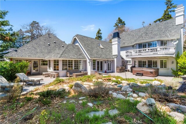1031 Black Oaks Dr, Lake Arrowhead, CA 92352 - back of property with a hot tub, a chimney, a patio, and stucco siding