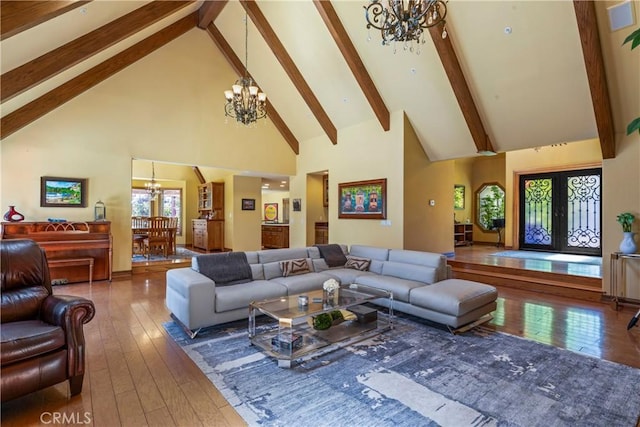 1031 Black Oaks Dr, Lake Arrowhead, CA 92352 - living room with a chandelier, high vaulted ceiling, hardwood / wood-style flooring, and beam ceiling