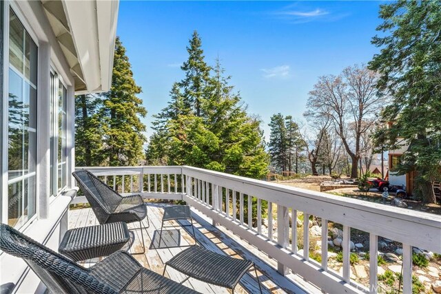 1031 Black Oaks Dr, Lake Arrowhead, CA 92352 - wooden terrace with view of wooded area